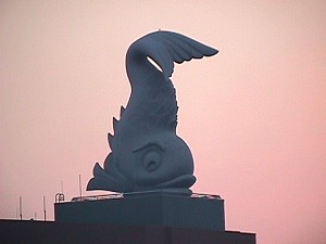 A dolphin fish on top of the same named resort building.